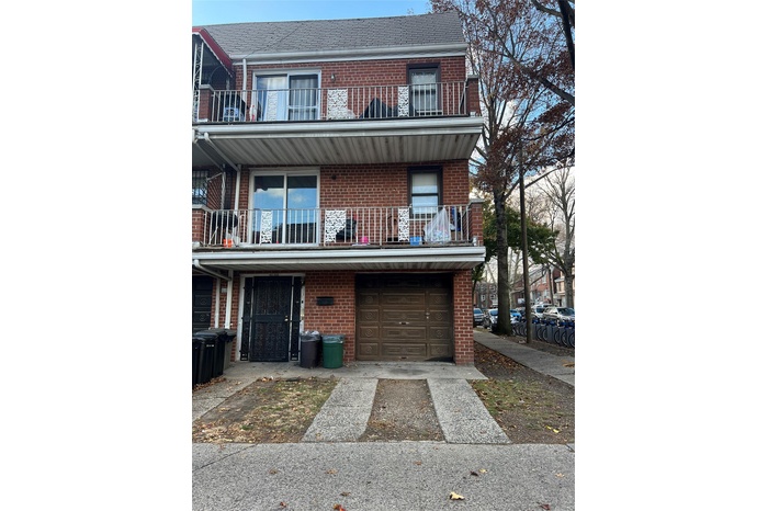 Multi unit property with a balcony and a garage