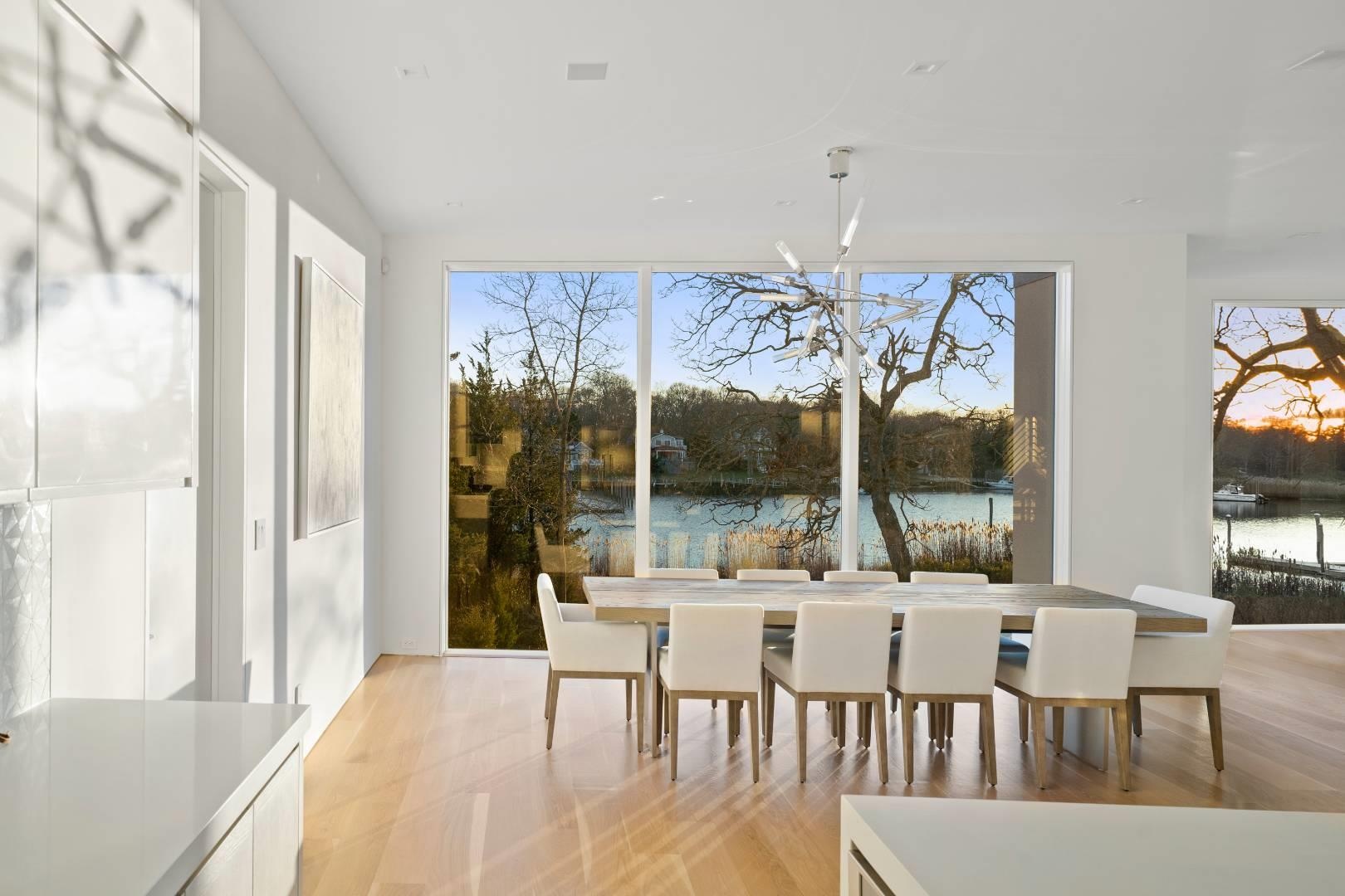 Dining room featuring a healthy amount of sunlight and a water view