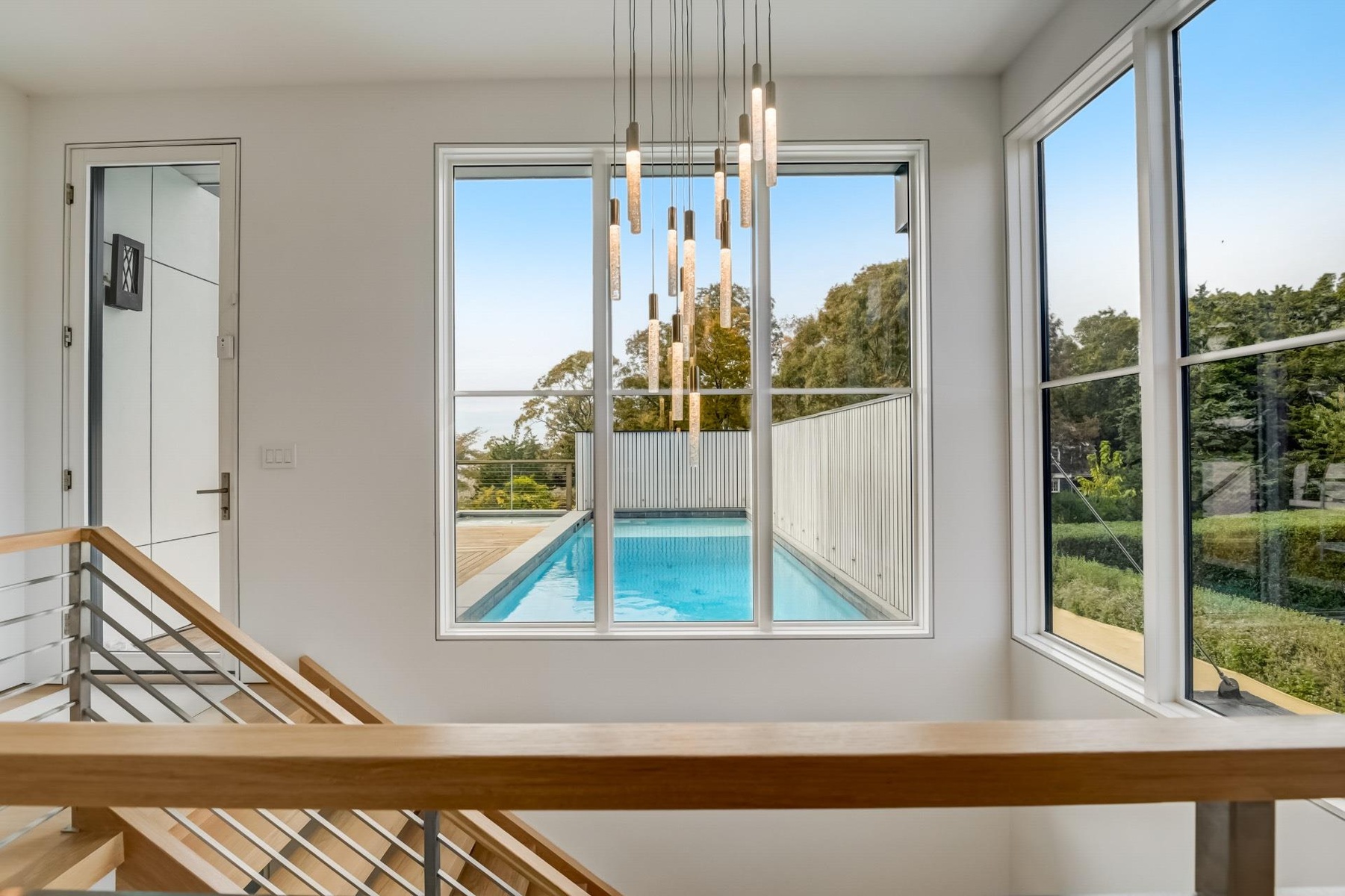 View of swimming pool with a chandelier