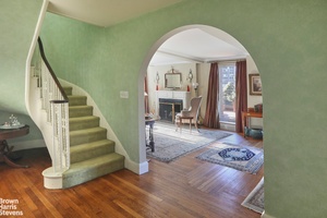 On the first level, an inviting foyer leads to a spacious living and dining area.