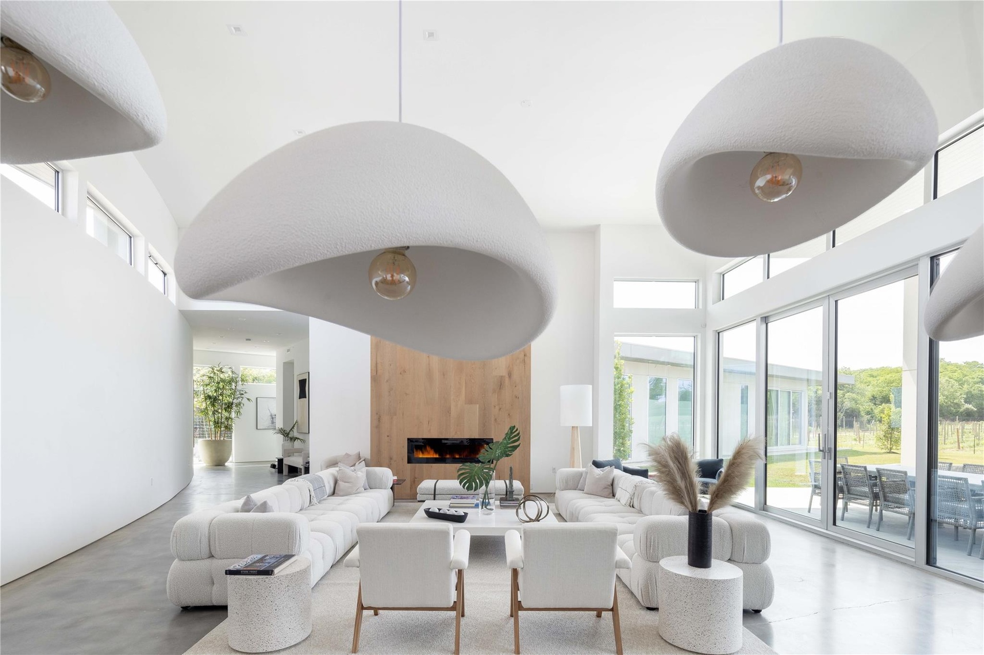 Living room with a fireplace and a high ceiling