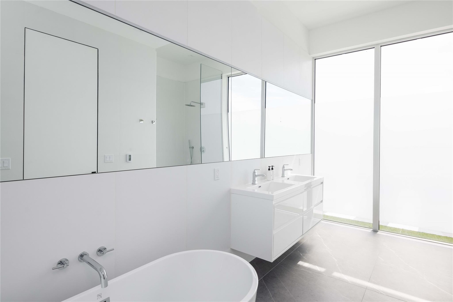Bathroom featuring tile patterned floors, a tub to relax in, and vanity