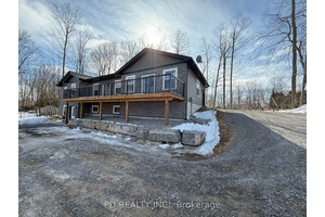 Stunning 3 2 bedroom, 3 bathroom, 2 kitchen bungalow on a treed 1 acre lot.