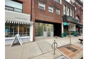 2732 sq ft of upgraded, modern storefront retail space with 11 to 16 foot ceilings suitable for various types of business.