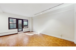 This spacious alcove studio is located in a wonderful Tudor City cooperative building.