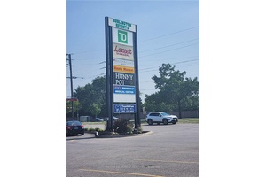 Busy neighborhood shopping centre at signalized intersection of Guelph Line and Upper Middle Road.