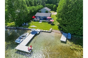 Life at the lake ! ! This delightful two bedroom cottage is set on a large lot on the shore of Williams Lake, a preferred location for summer family fun.