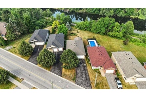 Beautifully maintained 2 1 raised bungalow, 3 washrooms, finished basement with gas fireplace, lovely sunroom, and a beautiful view of the Scugog river.