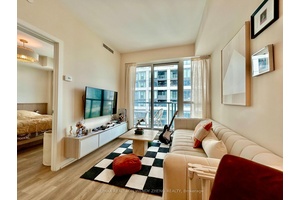 Step into this immaculate, condo at Liberty Central by the Lake II, where modern elegance meets lakeside tranquility.