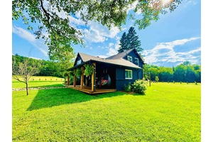 Nestled among what is locally known as the whispering pines, sits this beautifully renovated farmhouse on a 2.