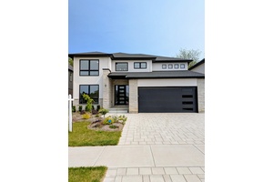 This two storey executive home displays impressive curb appeal with natural stone, brick, and stucco combined with enlarged windows and front door with side lights, and a large covered outdoor ...