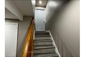 Spacious One Bedroom Basement Apartment featuring a private entrance, separate living area, and a full kitchen.