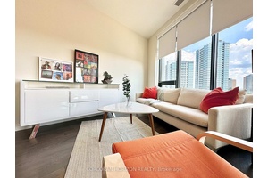 Top floor furnished studio with premium garage parking at Midtown Lofts.