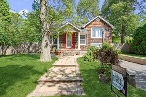 Nestled in a charming North Shore beach community, this delightful three level home offers the perfect retreat for those seeking tranquil coastal living with convenient access to local attractions.