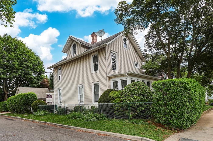 View of property exterior with a chimney