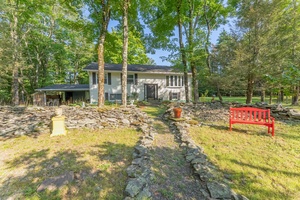 Located on a quiet, country road is this meticulously maintained raised ranch home with ample privacy.