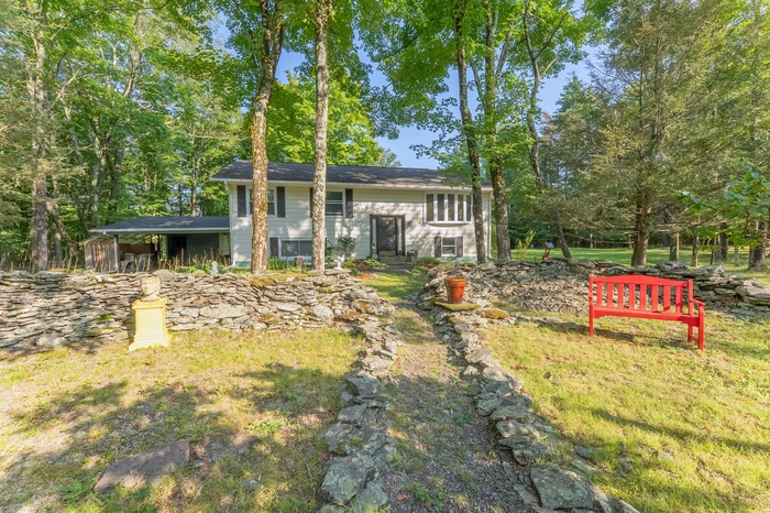Raised ranch featuring view of scattered trees