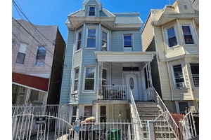 Multi family home in the Fordham section features one 4 bedroom apt and two 3 bedroom apts with an unfinished walkout bsmt.