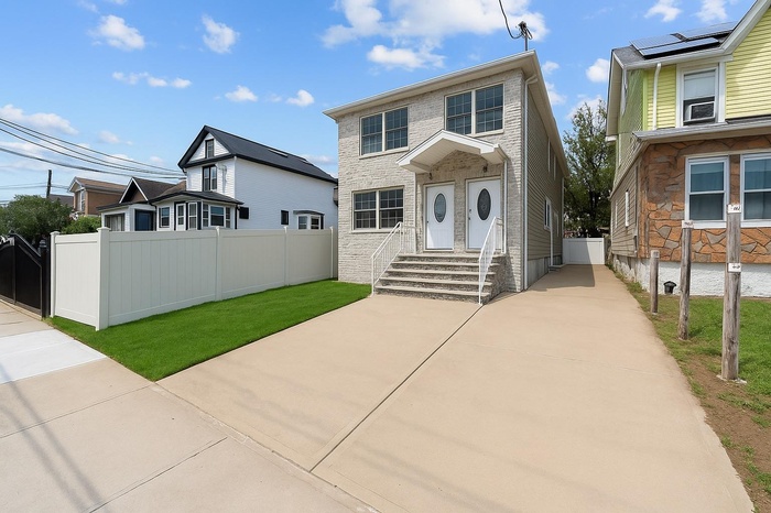 View of front of house featuring entry steps and stone siding