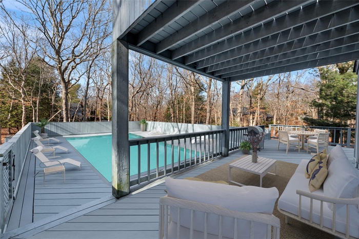 Back yard Wooden terrace with a fenced in pool