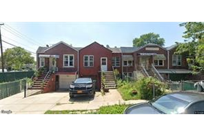 View of front of home with stairway, driveway, and a garage