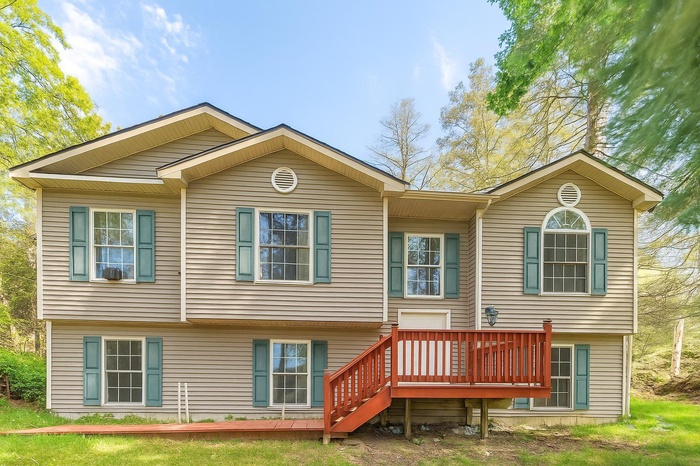 Rear view of house with a wooden deck