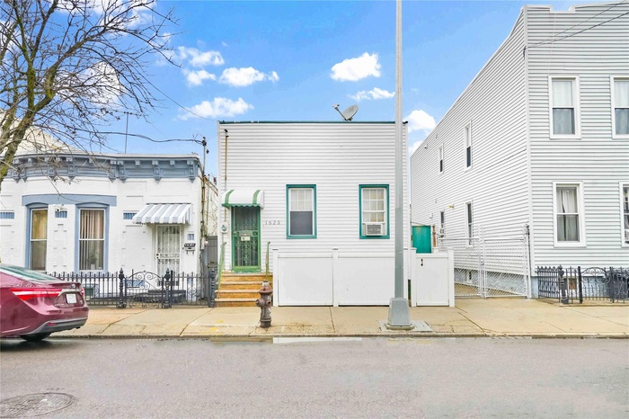 Multi unit property featuring a fenced front yard
