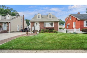 Welcome to this beautifully maintained brick cape style home nestled in the heart of Elmont.