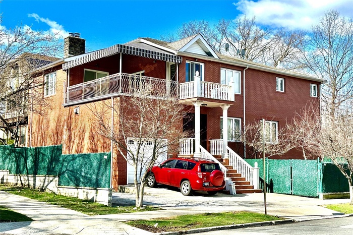 View of building exterior with an attached garage and driveway