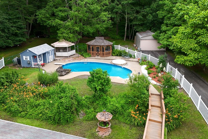 View of swimming pool with a gazebo, a fenced backyard, an outdoor structure, and a patio area