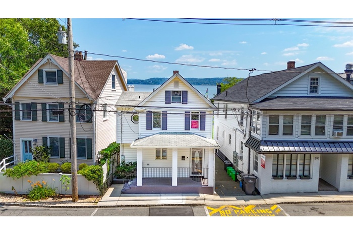 View of front facade with covered porch and a water and mountain view