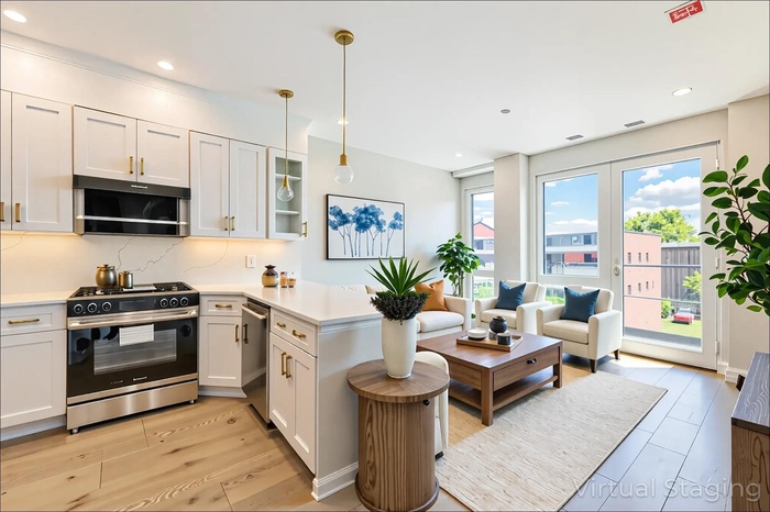 Kitchen featuring stainless steel appliances, a peninsula, light countertops, decorative light fixtures, and glass insert cabinets