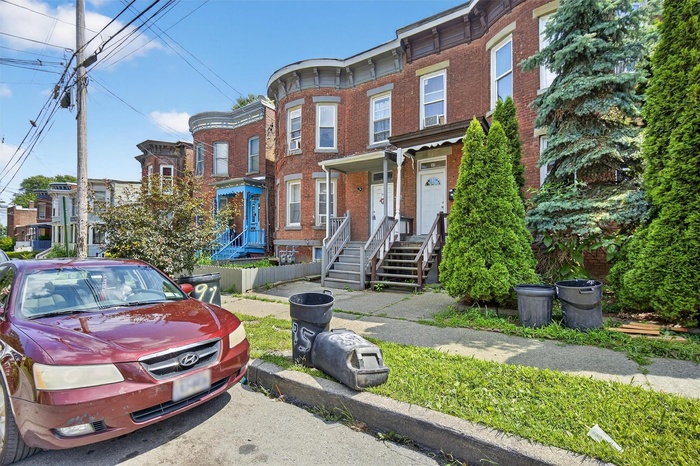 Italianate home featuring brick siding