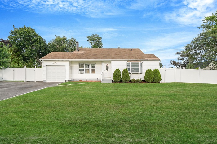 View of front facade with an attached garage, driveway, and crawl space