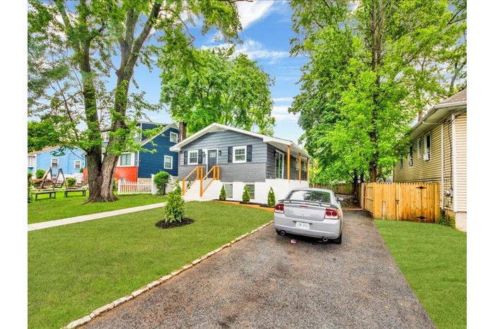 View of front of home featuring asphalt driveway