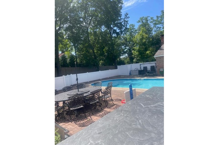View of swimming pool with a fenced backyard, a patio area, and outdoor dining area