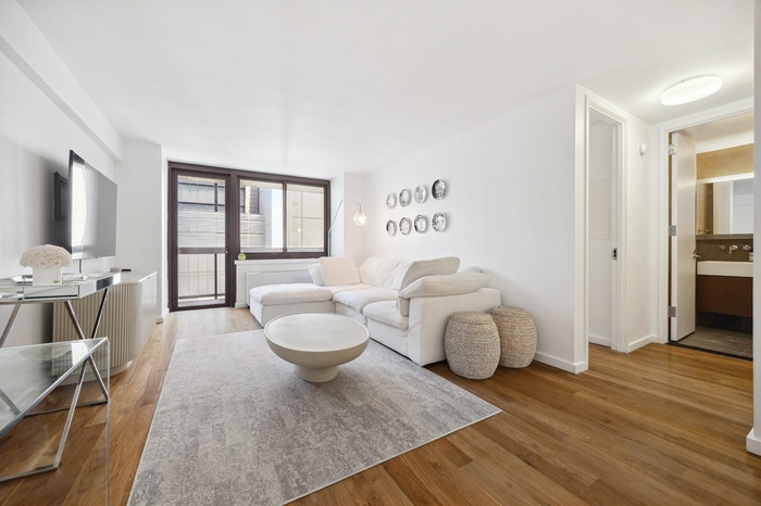 Living room with light wood-style floors and baseboards