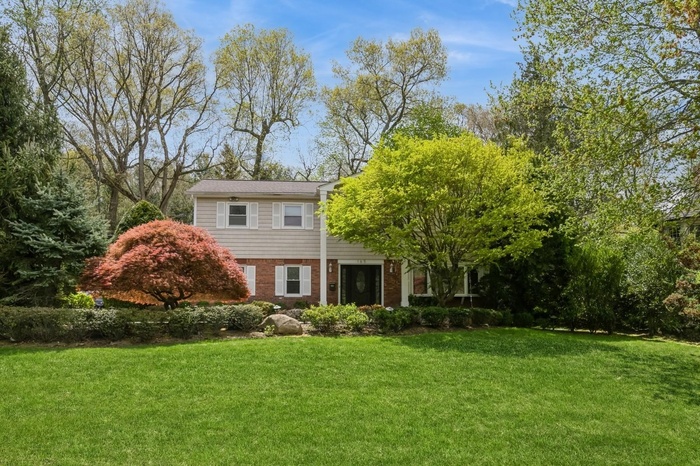 View of front of house featuring a front yard and brick siding