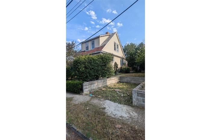 View of side of home featuring a chimney