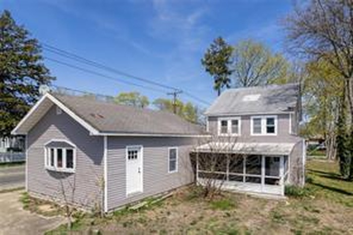 Rear view of house with a sunroom