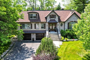 Quality custom built raised bungaloft with elevator, set on a beautifully landscaped lot.