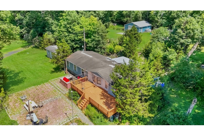 View of subject property front of home & upper acreage with pole barn