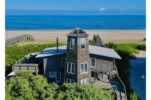 Welcome to The Tower House, a renowned architectural gem perched directly on the oceanfront in the heart of Davis Park, Fire Island.