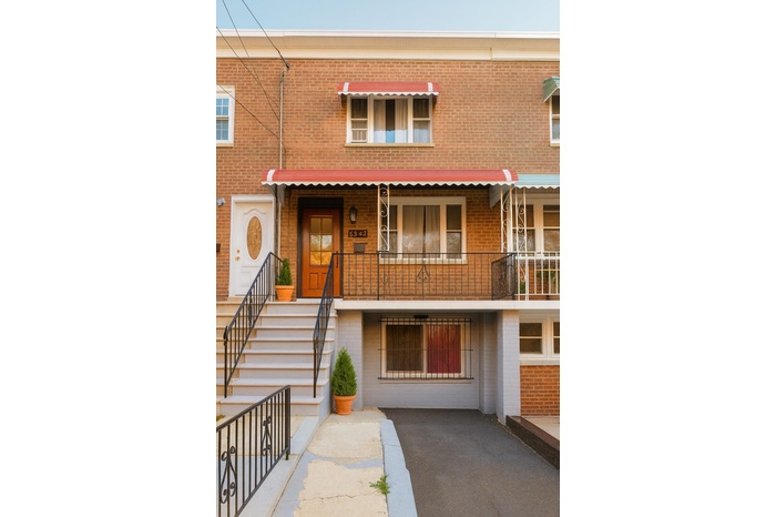 View of front of home with brick siding and stairway