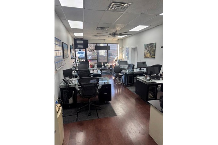 Office featuring hardwood / wood-style flooring, a drop ceiling, and ceiling fan
