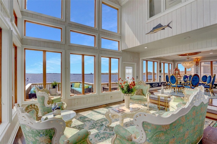 Living area with water view and towering ceiling