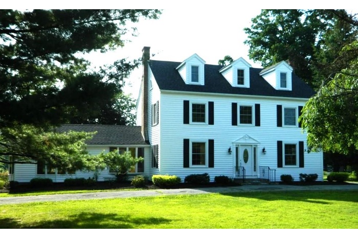 View of front of home featuring a front yard and a chimney