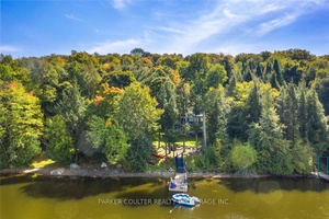 Discover the perfect getaway at this charming 2 storey home nestled on the shores of Three Mile Lake.