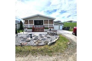 A charming bungalow nestled on Lakeside Drive, offering stunning views and an unparalleled sense of tranquility.