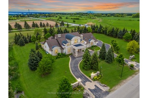 Impeccably nestled in The Bluffs, this extraordinary estate spans over 11, 000 sqft.